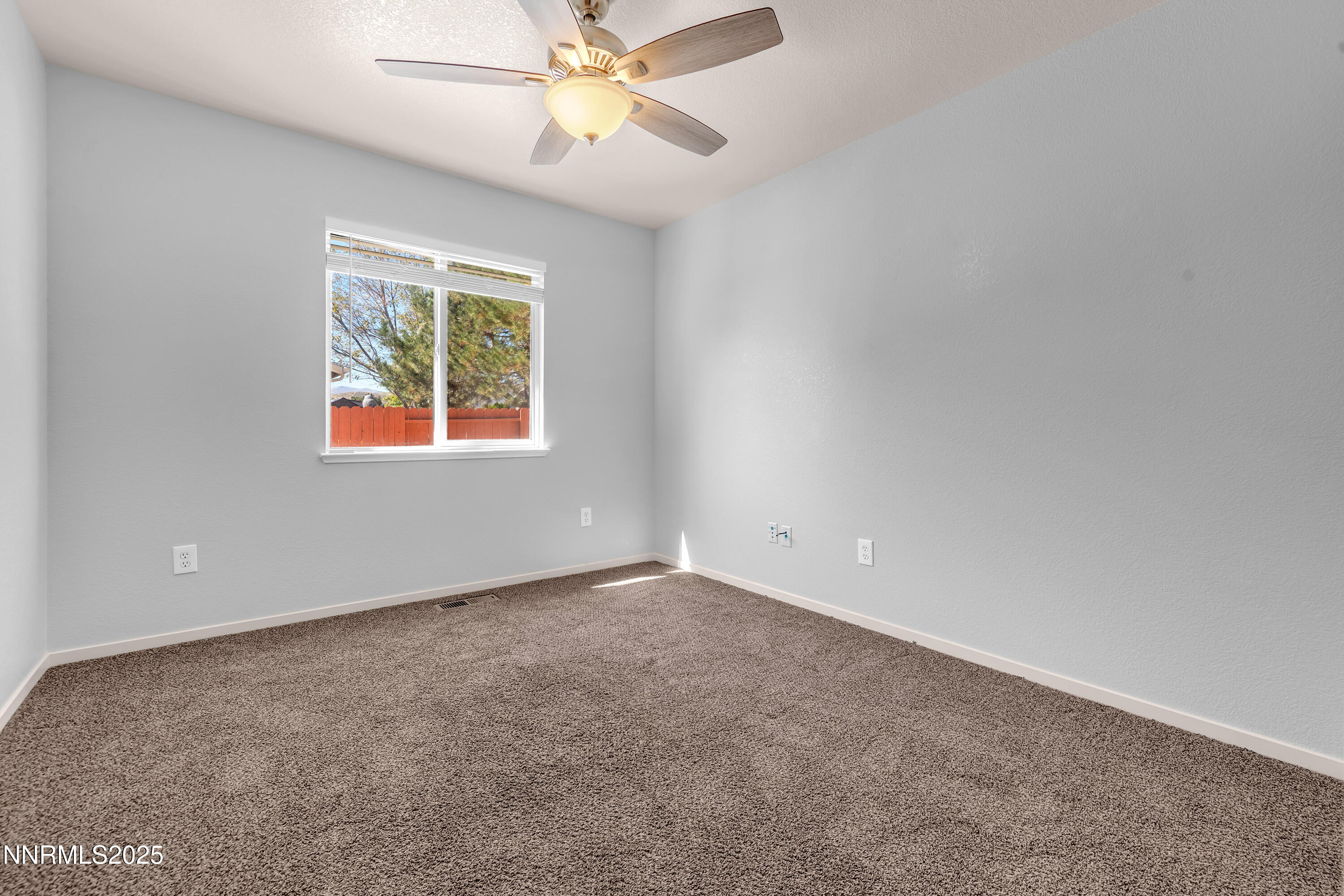 17507 Bear Lake Drive Reno, NV 89508 - Photo 31 of 42 an empty room with windows and fan