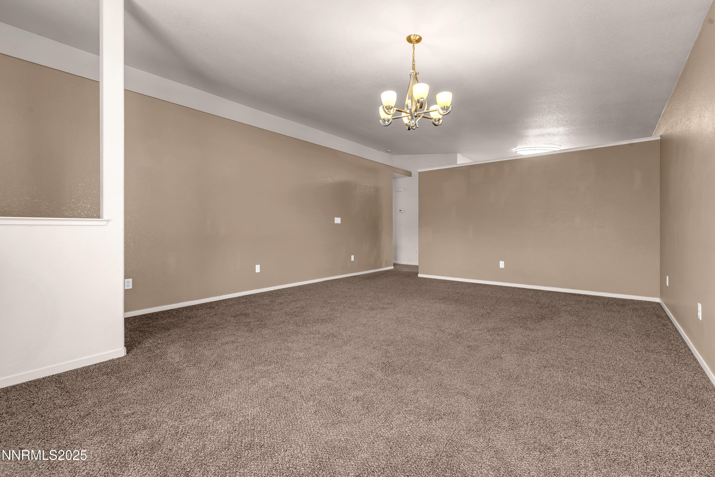 17507 Bear Lake Drive Reno, NV 89508 - Photo 4 of 42 a view of an empty room with a chandelier