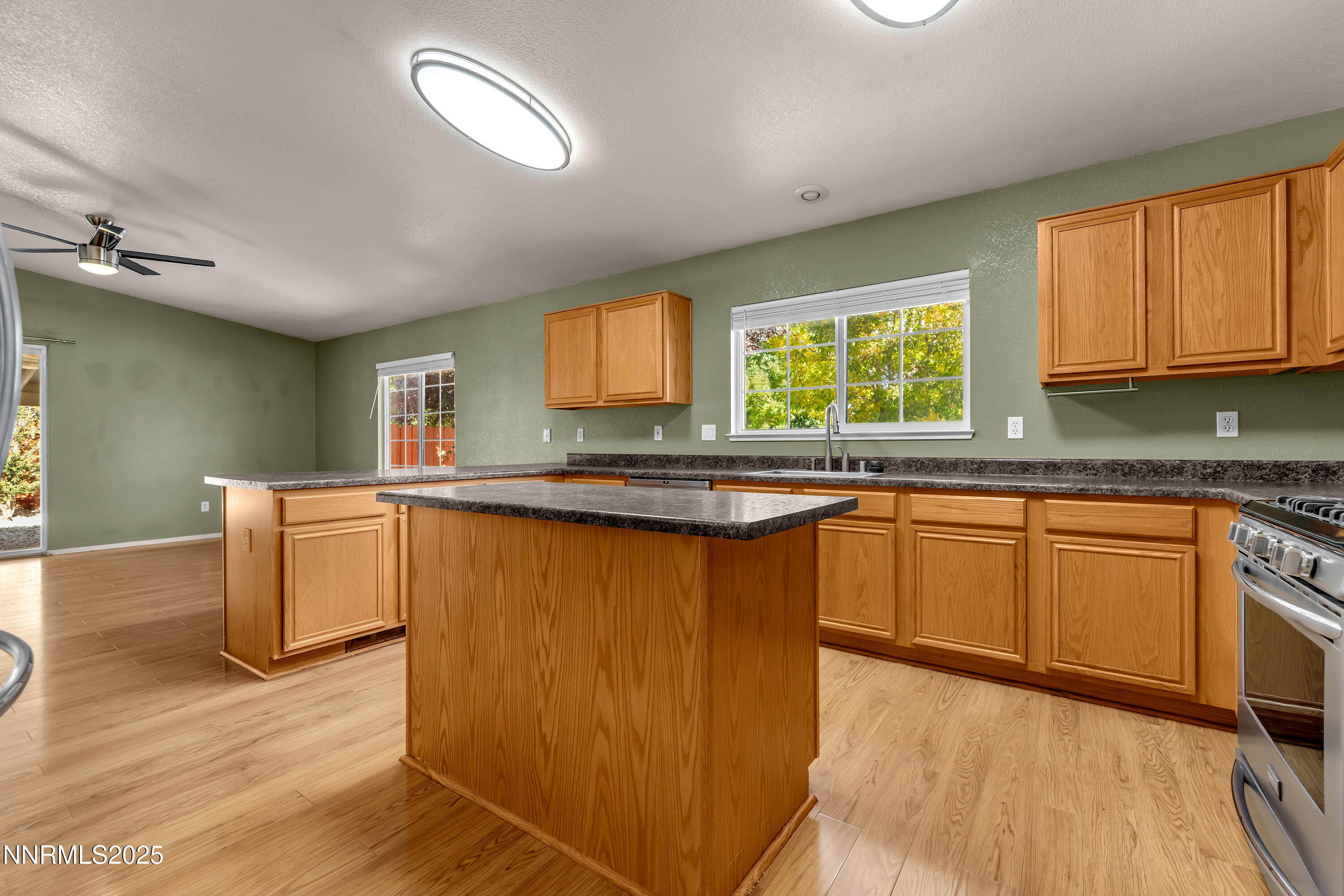 17507 Bear Lake Drive Reno, NV 89508 - Photo 10 of 42 a kitchen with granite countertop a stove a sink and a microwave