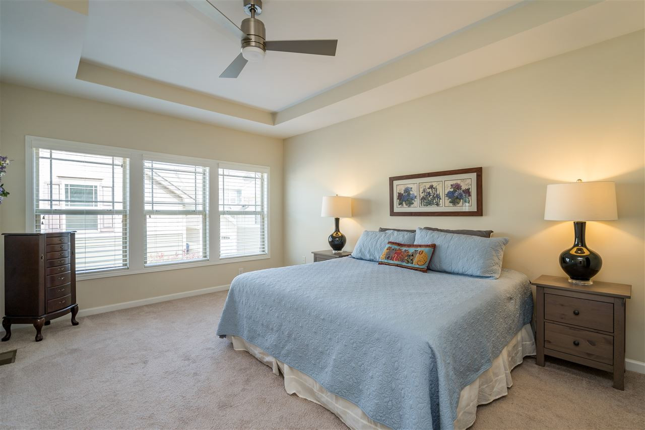 5630 Wade Park Boulevard Raleigh, NC 27607 - Photo 17 of 30 Owner's suite features a tray ceiling, ceiling fan, WIC with wooden shelving, and en suite spa-like bathroom! Owner's Suite