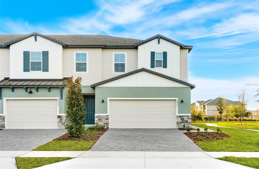 1129 Orange Trailside Way Ocoee, FL 34761 - Photo 2 of 32 a front view of a house with a yard and garage