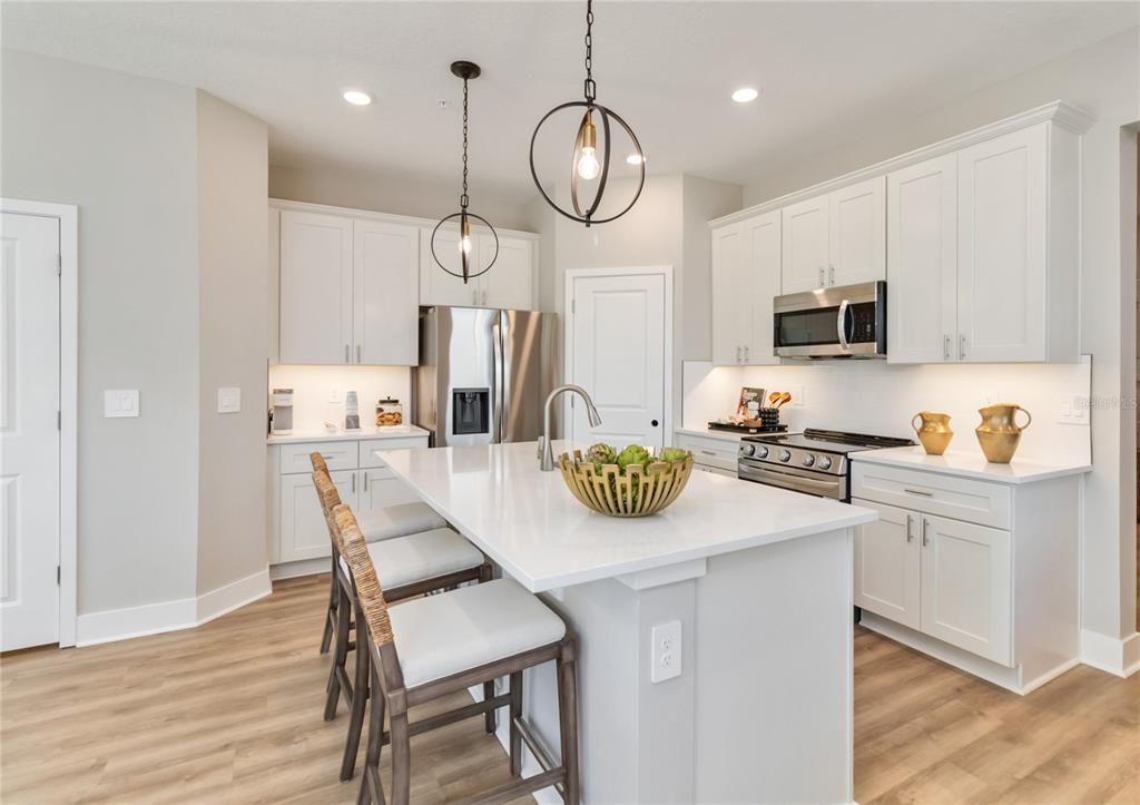 1129 Orange Trailside Way Ocoee, FL 34761 - Photo 7 of 32 a kitchen with a dining table and chairs