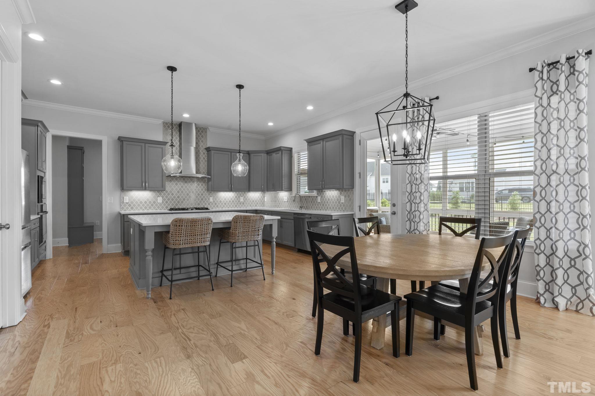 3157 Beechcroft Lane Apex, NC 27502 - Photo 15 of 42 a dining room with stainless steel appliances kitchen island a table and chairs
