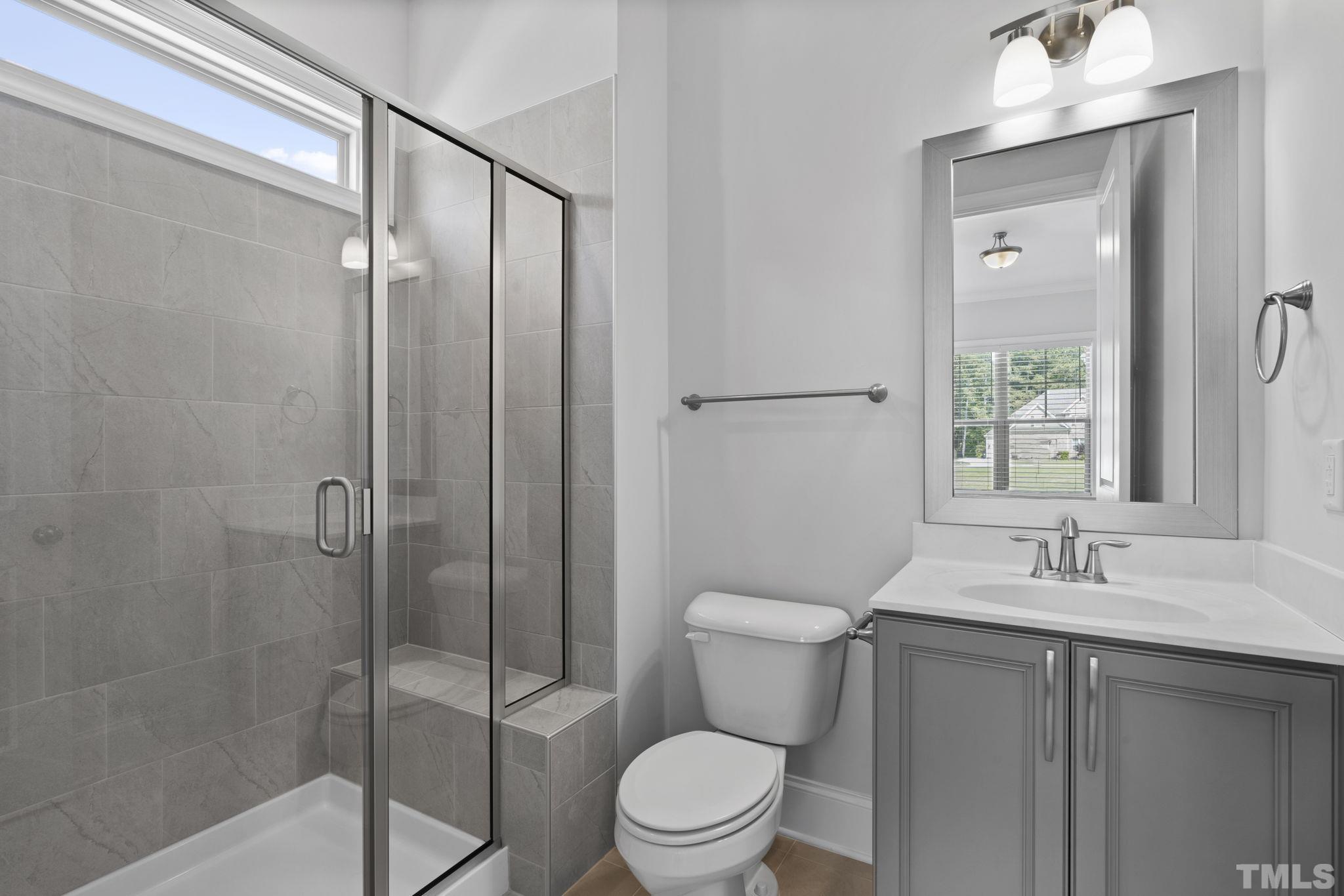 3157 Beechcroft Lane Apex, NC 27502 - Photo 21 of 42 a bathroom with a sink a toilet and shower