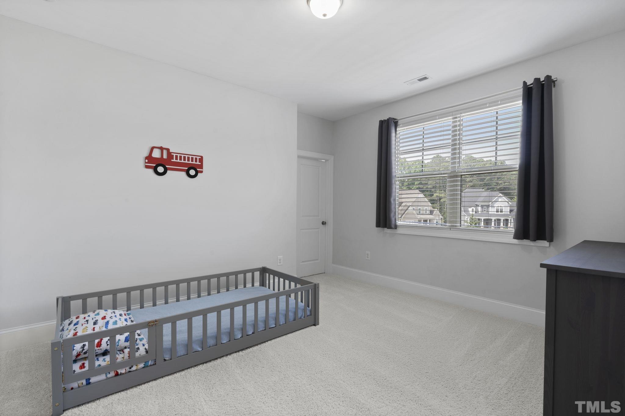 3157 Beechcroft Lane Apex, NC 27502 - Photo 27 of 42 a bedroom with furniture and a window