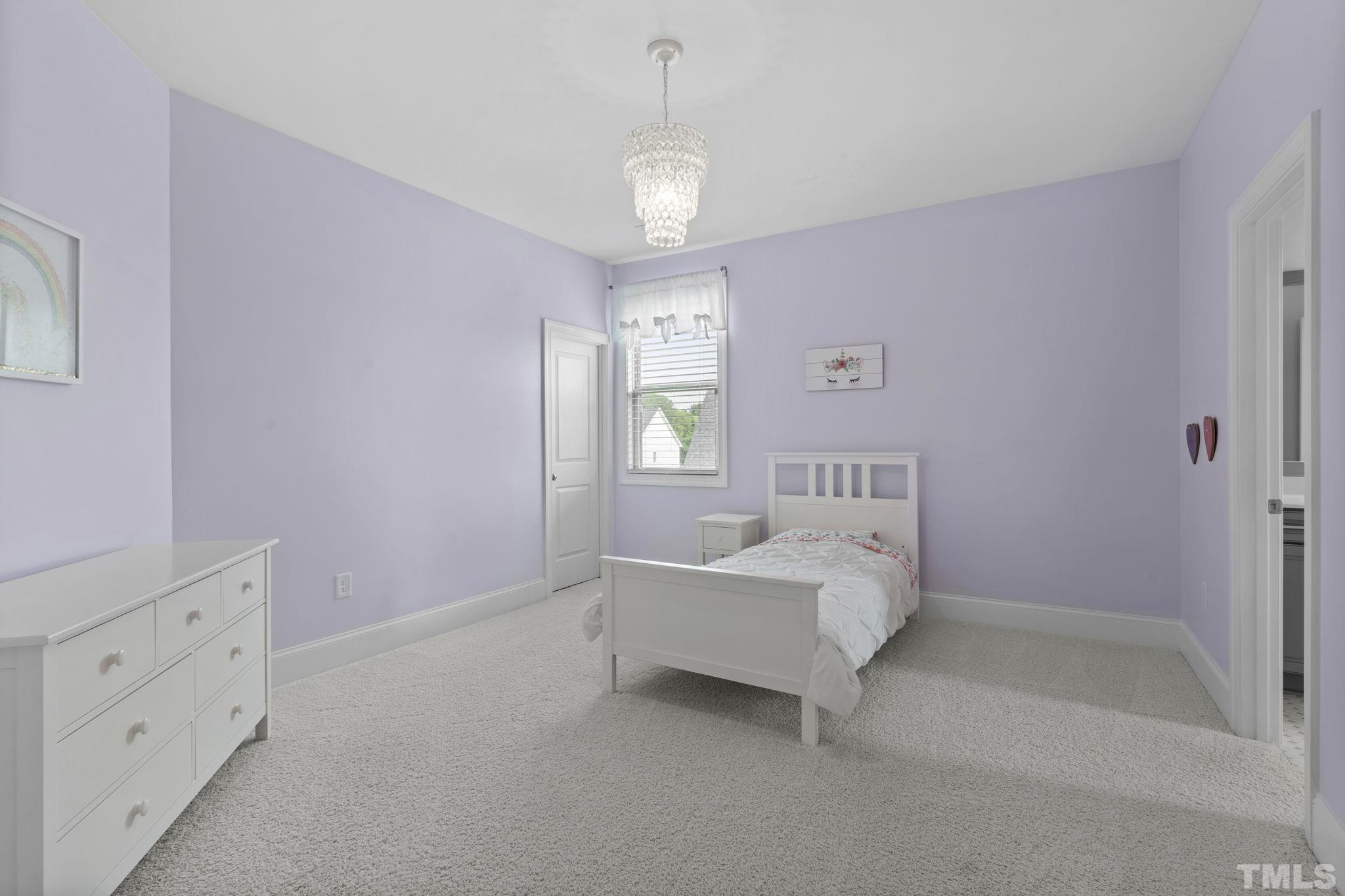 3157 Beechcroft Lane Apex, NC 27502 - Photo 32 of 42 a spacious bedroom with a bed and a window