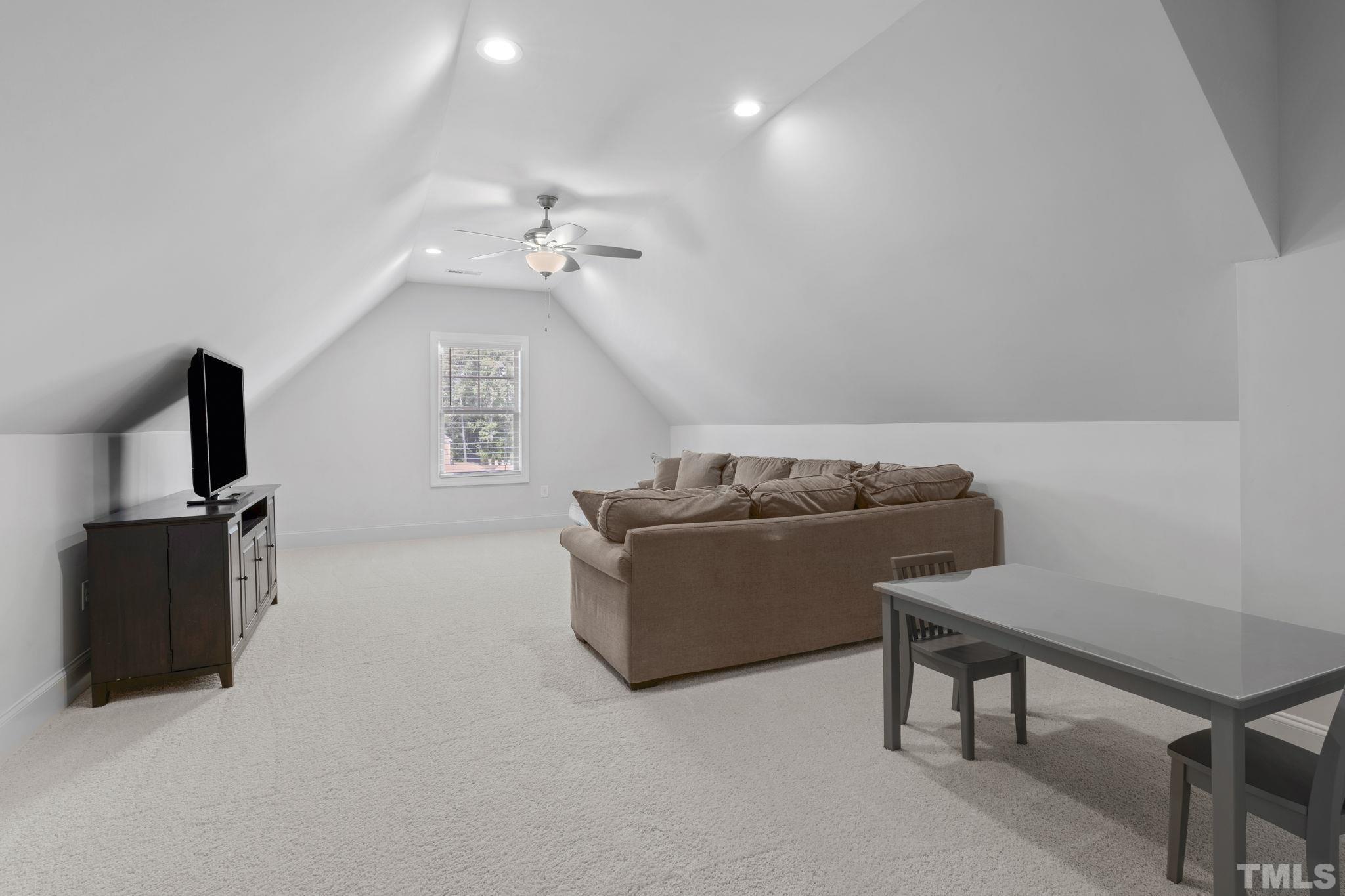 3157 Beechcroft Lane Apex, NC 27502 - Photo 34 of 42 a living room with furniture and a flat screen tv