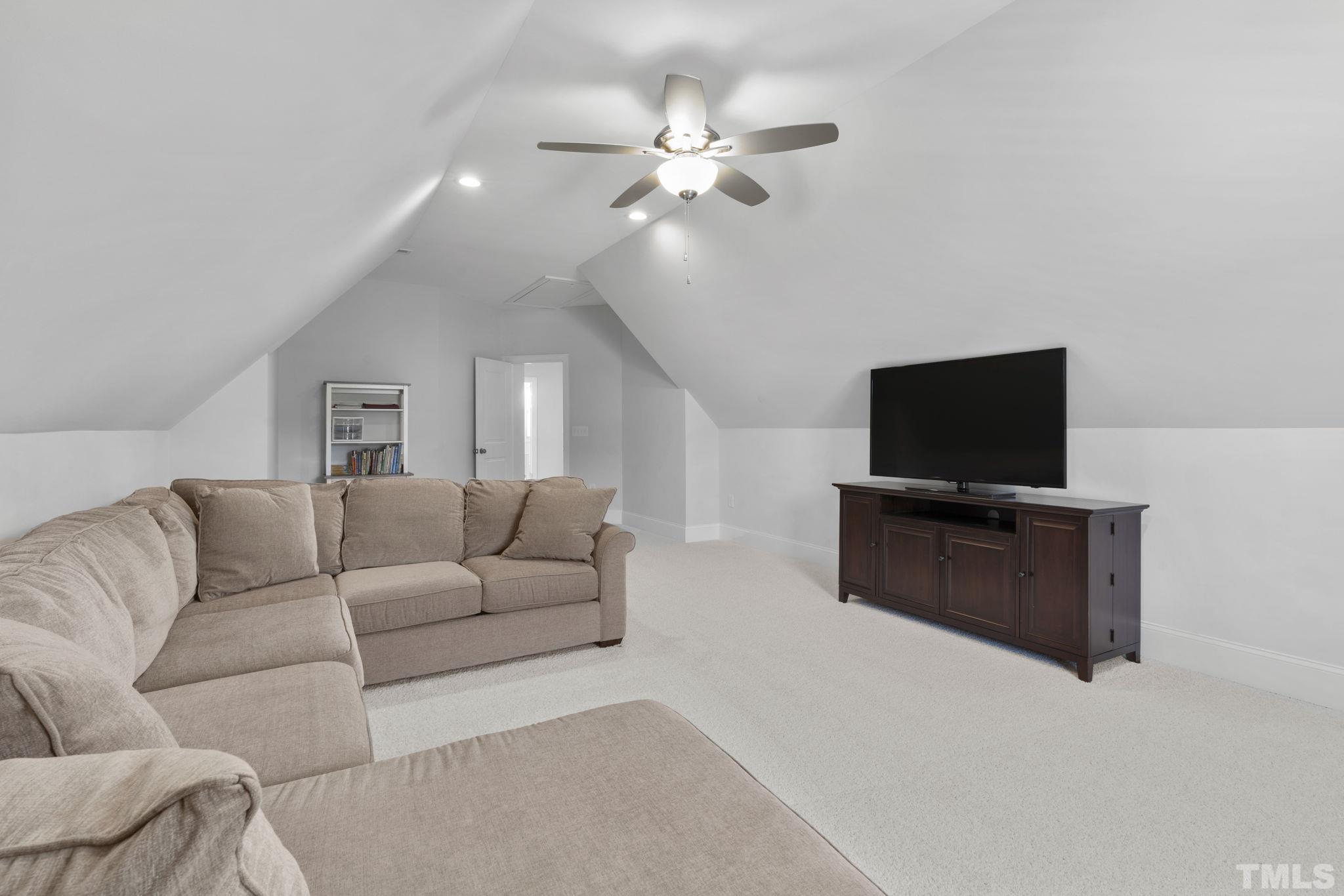 3157 Beechcroft Lane Apex, NC 27502 - Photo 35 of 42 a living room with furniture and a flat screen tv