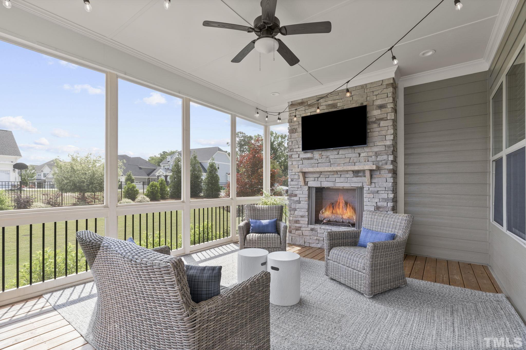 3157 Beechcroft Lane Apex, NC 27502 - Photo 36 of 42 a living room with furniture fireplace and a flat screen tv