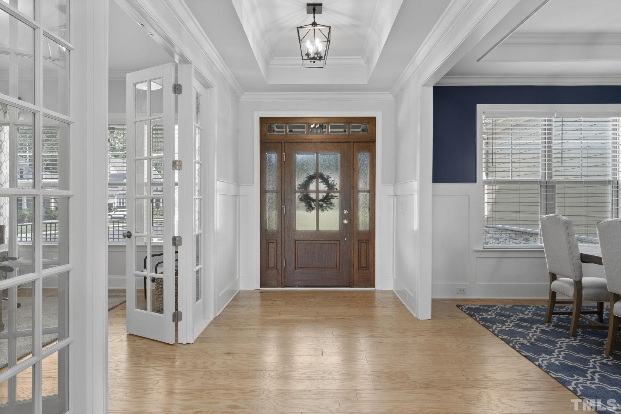 3157 Beechcroft Lane Apex, NC 27502 - Photo 5 of 42 a view of a hallway with wooden floor and staircase