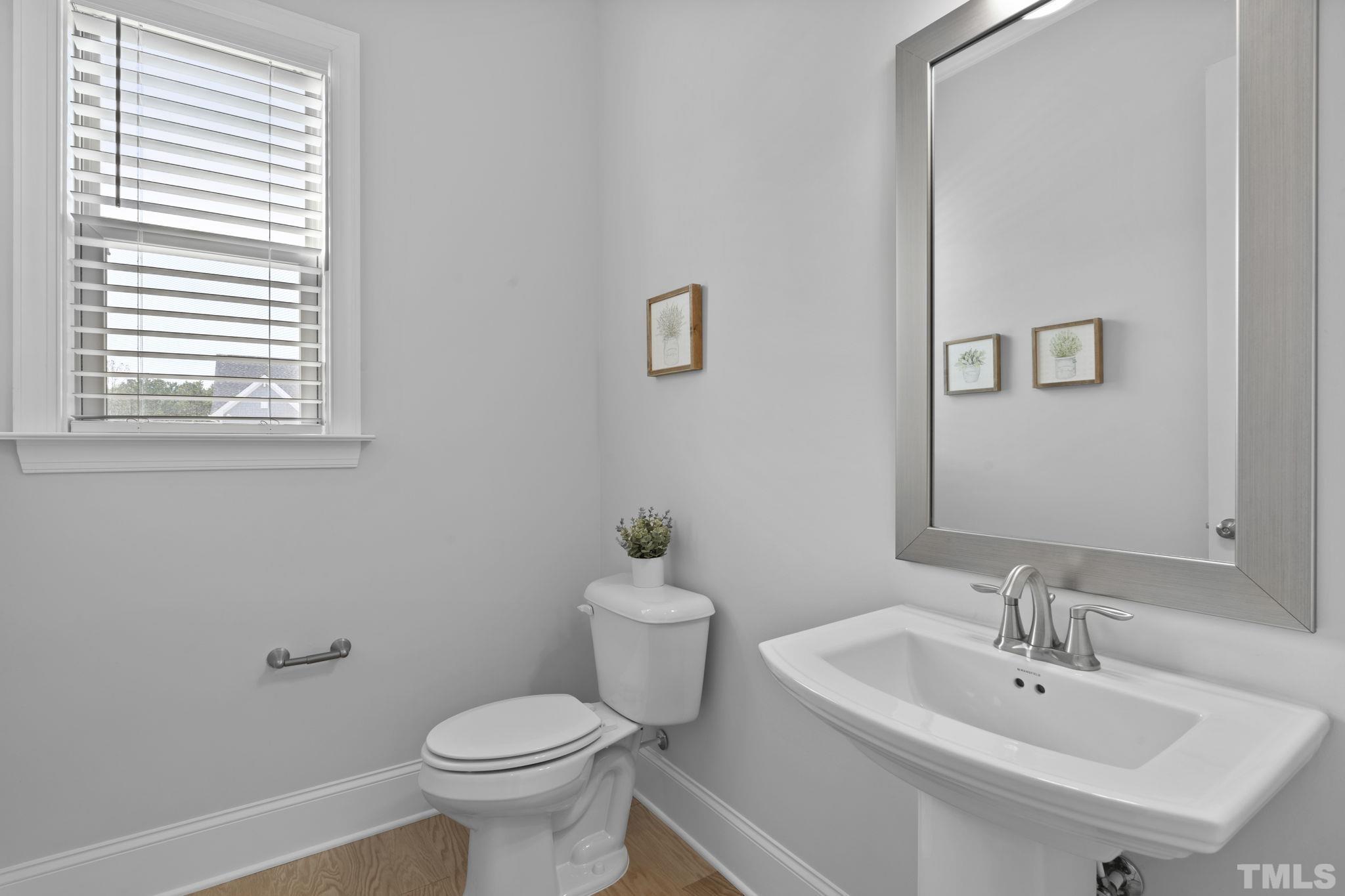 3157 Beechcroft Lane Apex, NC 27502 - Photo 10 of 42 a bathroom with a sink a toilet and a mirror