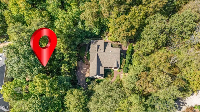 a aerial view of a house with swimming pool and red chairs