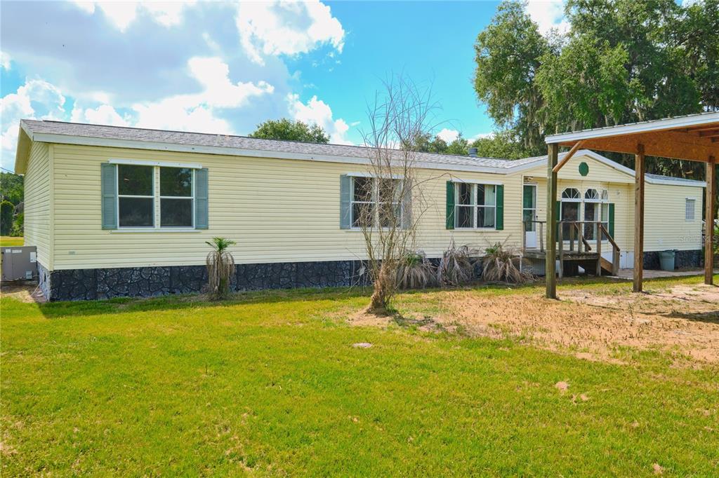 2701 Murphy Road Ona, FL 33865 - Photo 4 of 41 a backyard of a house with yard table and chairs
