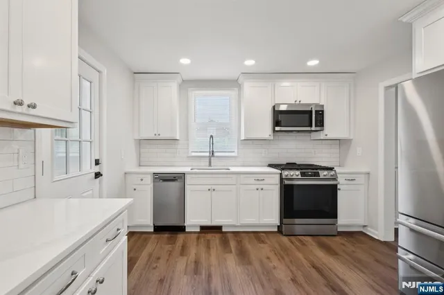 a kitchen with a sink stove and refrigerator