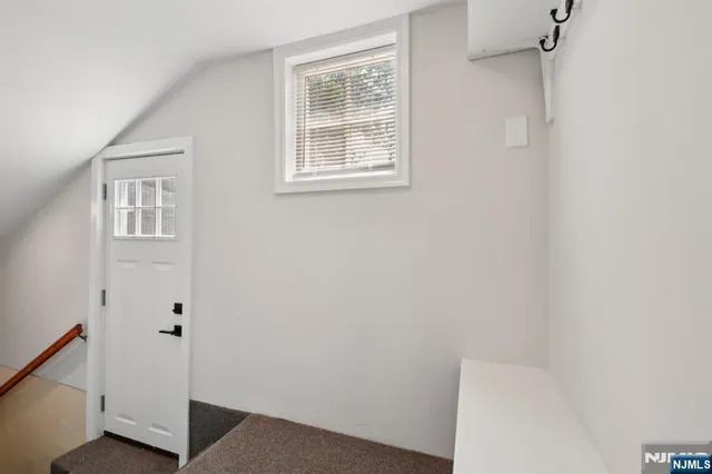 a kitchen with a refrigerator and a stove top oven