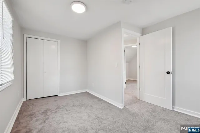 a view of a house with a yard and large tree