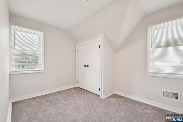 a kitchen with kitchen island granite countertop a sink stove and refrigerator