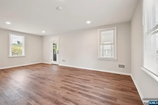 a view of a kitchen with wooden floor and electronic appliances