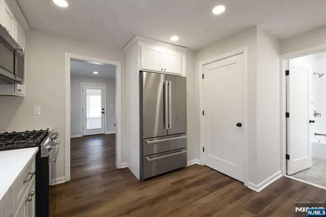 a kitchen with a sink cabinets and wooden floor