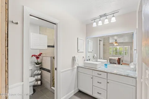 a bedroom with a bed lamp on table and a window