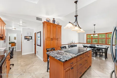 a kitchen with stainless steel appliances granite countertop a stove refrigerator and cabinets