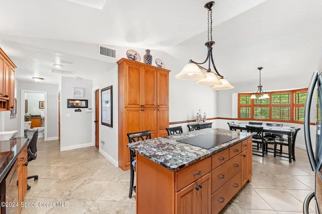 a kitchen with stainless steel appliances granite countertop a stove and refrigerator
