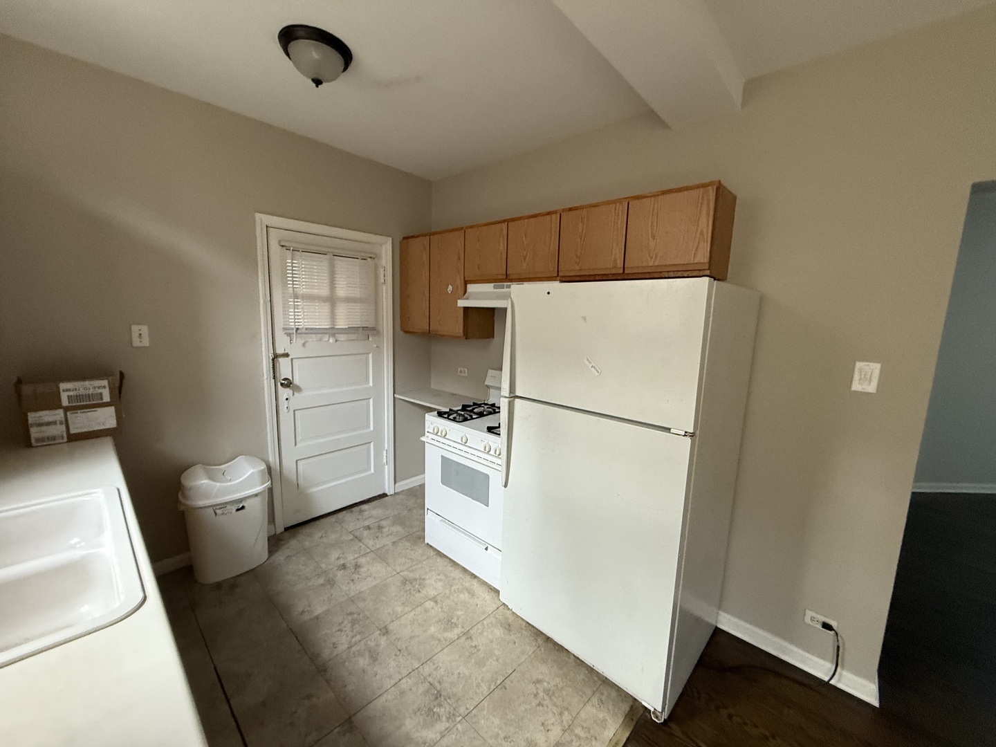 6848 32nd Street, Unit 4 Berwyn, IL 60402 - Photo 3 of 7 a kitchen with a refrigerator sink stove and cabinets