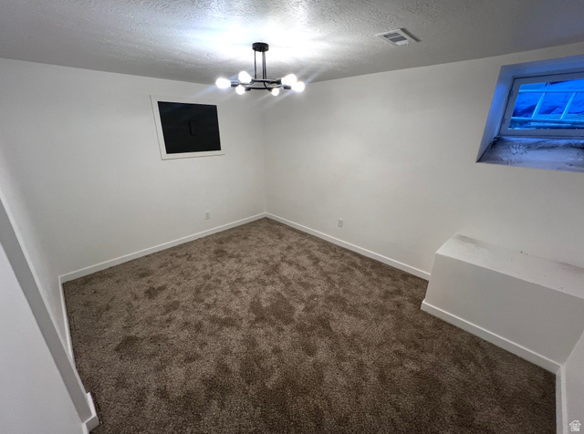 545 23rd Street Ogden, UT 84401 - Photo 18 of 28 Carpeted room featuring white walls, a modern multi-bulb ceiling light fixture, white baseboards, and a high-set window
