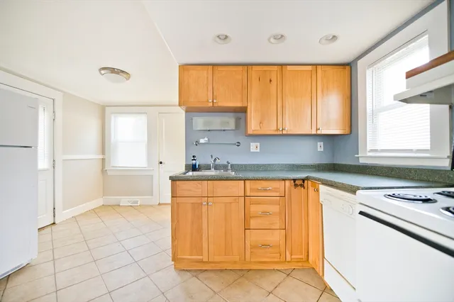 a kitchen with stainless steel appliances granite countertop a sink and a cabinets