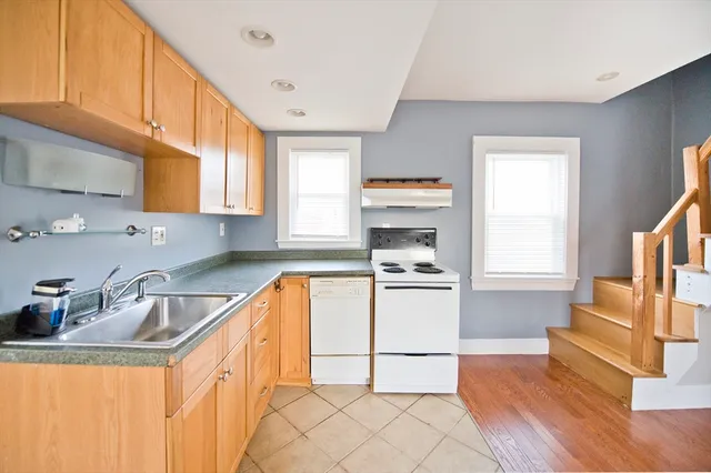 a kitchen with a sink a stove and a refrigerator