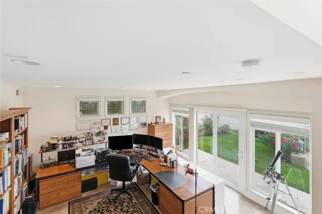 a living room with furniture a rug and a book shelf