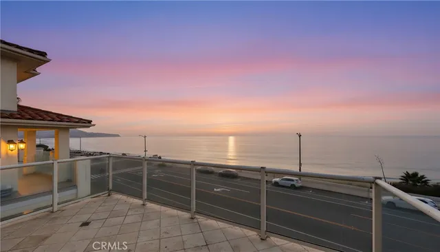 an aerial view of a city with ocean