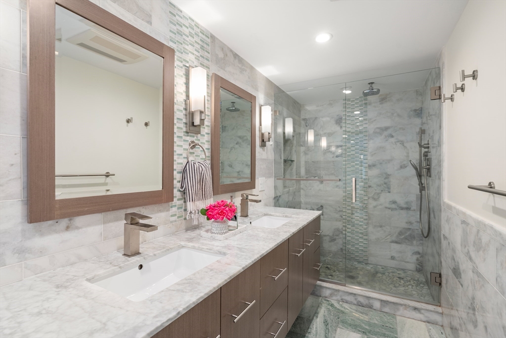 57 Marlboro Road Sudbury, MA 01776 - Photo 18 of 40 a bathroom with a granite countertop shower sink and mirror