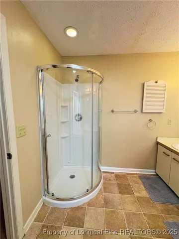 a bathroom with a glass shower door