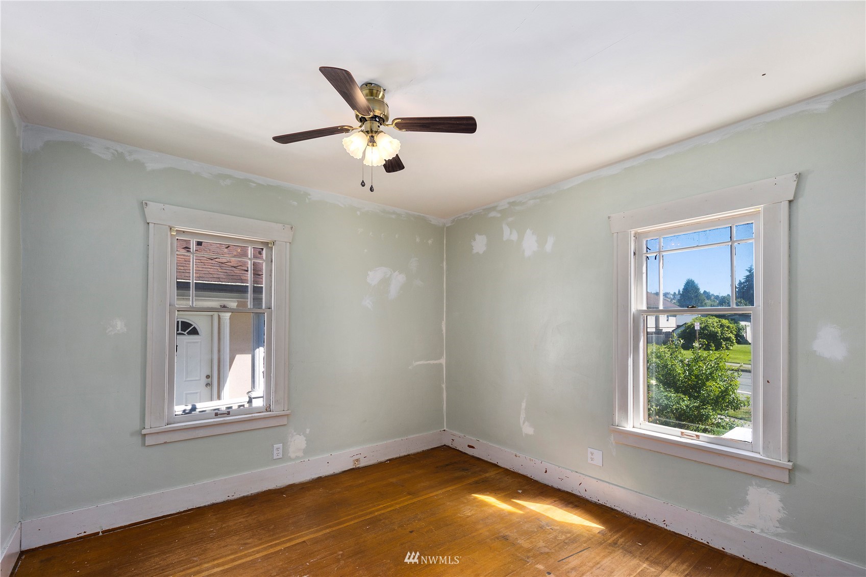 800 North 3rd Street Renton, WA 98057 - Photo 11 of 20 a view of an empty room with a window and wooden floor