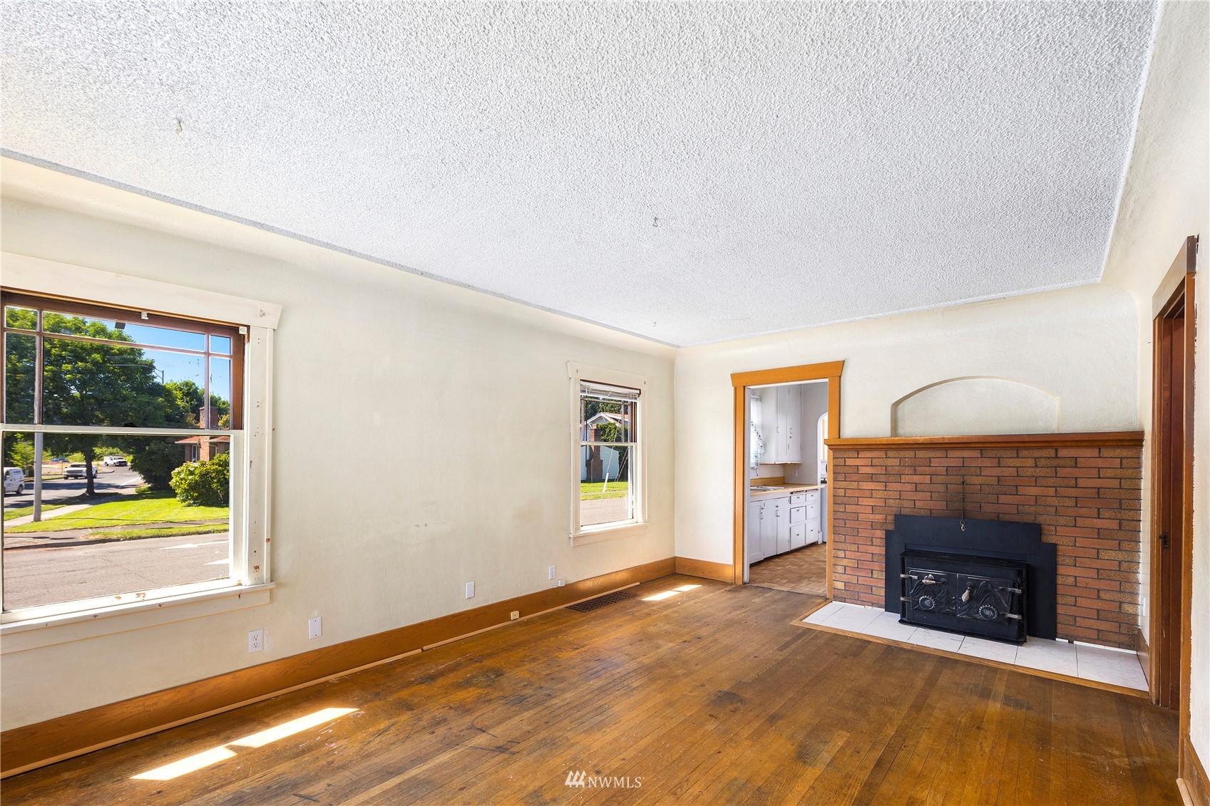 800 North 3rd Street Renton, WA 98057 - Photo 3 of 20 a view of an empty room with a window and a fireplace