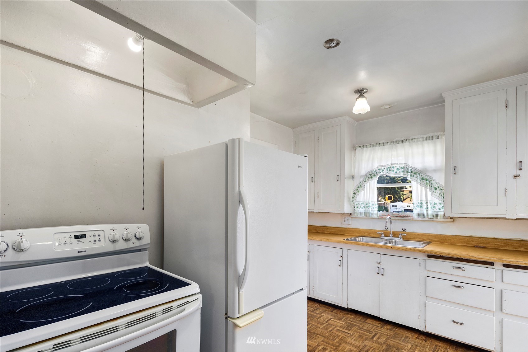 800 North 3rd Street Renton, WA 98057 - Photo 5 of 20 a kitchen with a refrigerator and a sink