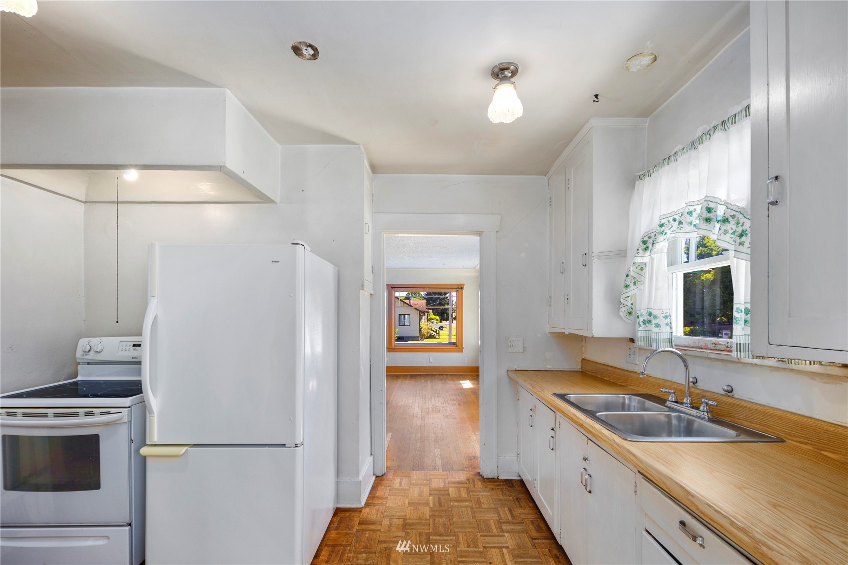 800 North 3rd Street Renton, WA 98057 - Photo 8 of 20 a kitchen with a sink and a refrigerator