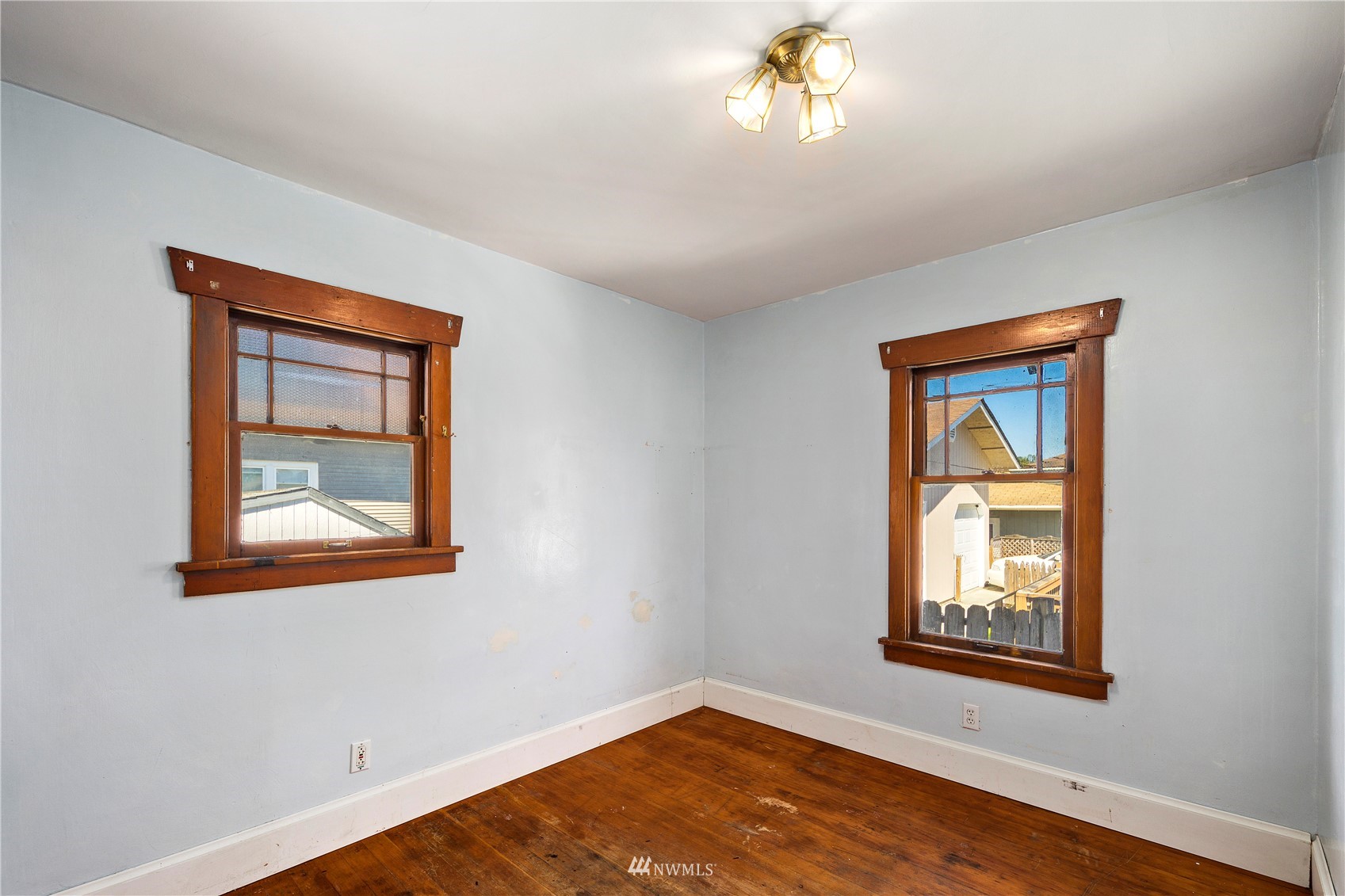 800 North 3rd Street Renton, WA 98057 - Photo 9 of 20 a view of an empty room with a window and wooden floor