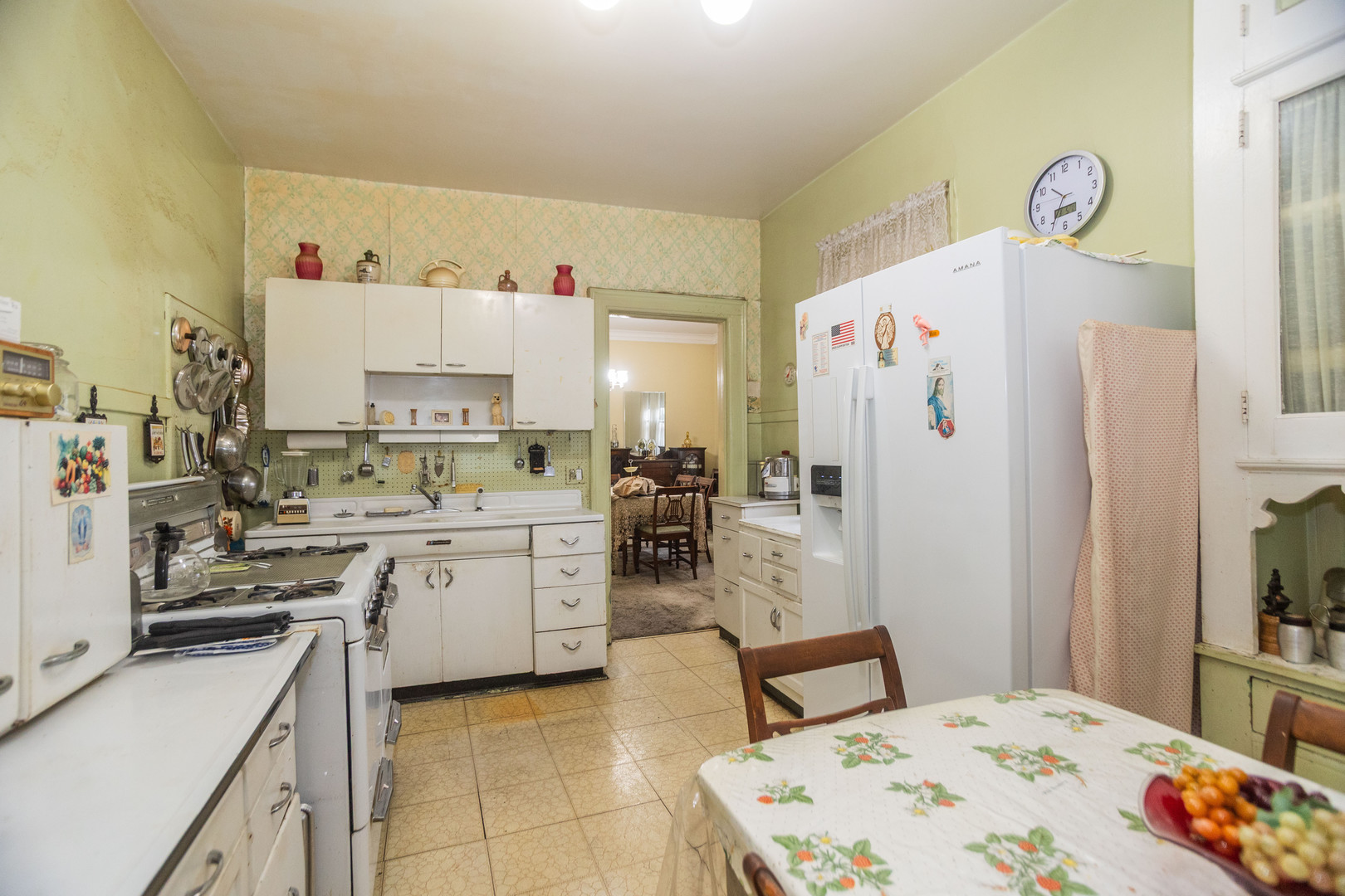 4155 West Grace Street Chicago, IL 60641 - Photo 12 of 30 a kitchen with a refrigerator and white cabinets
