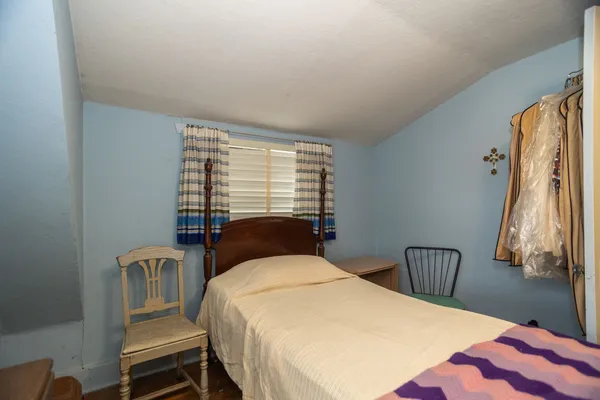 a bedroom with bed and window