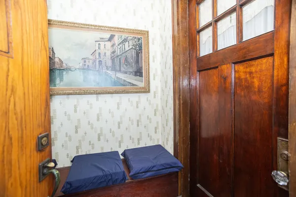 a living room with a couch and a painting on the wall