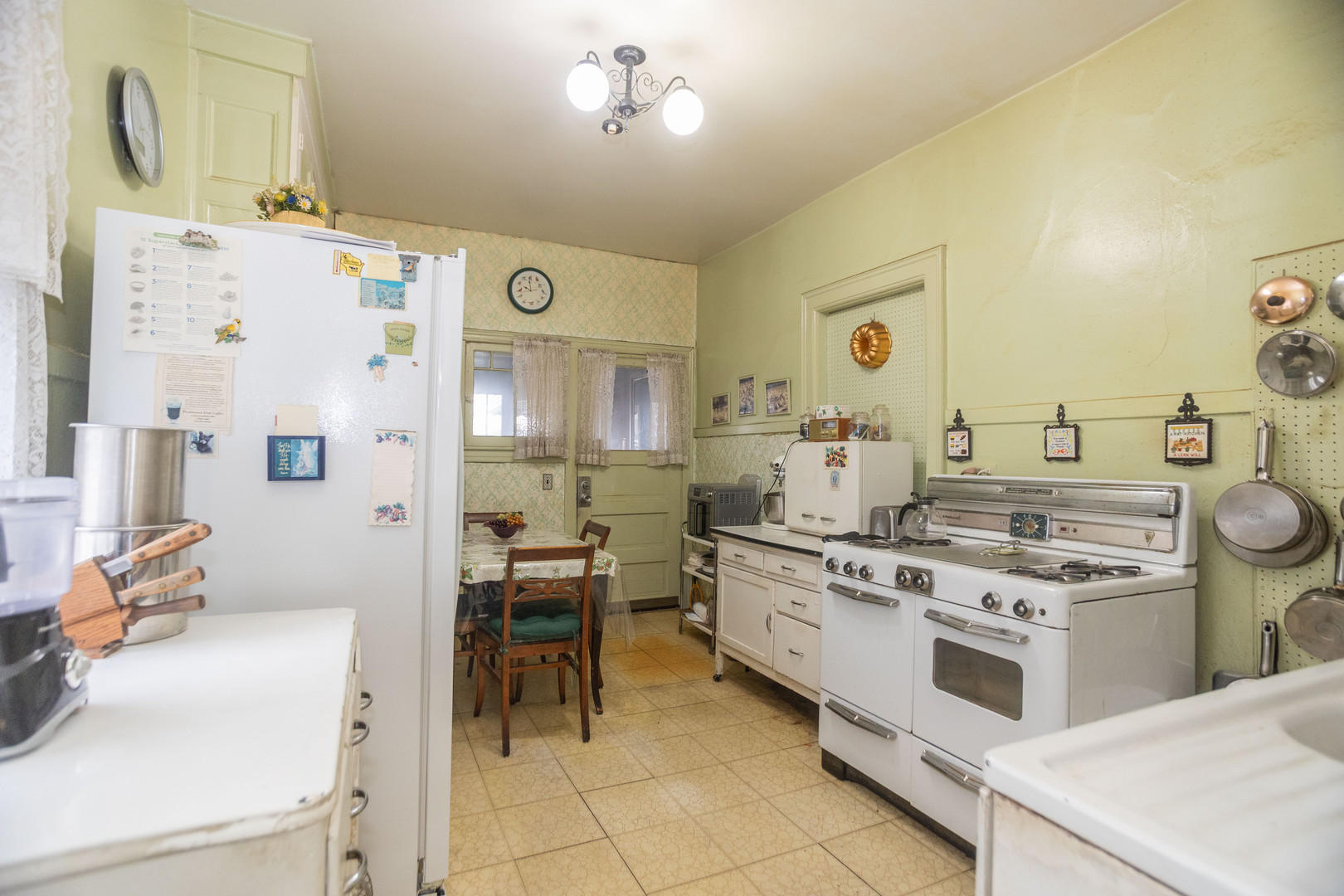 4155 West Grace Street Chicago, IL 60641 - Photo 10 of 30 a kitchen with a stove and chairs
