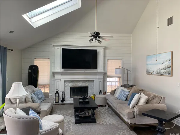 a living room with furniture a fireplace and a flat screen tv