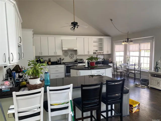 a kitchen with a table chairs stove and cabinets
