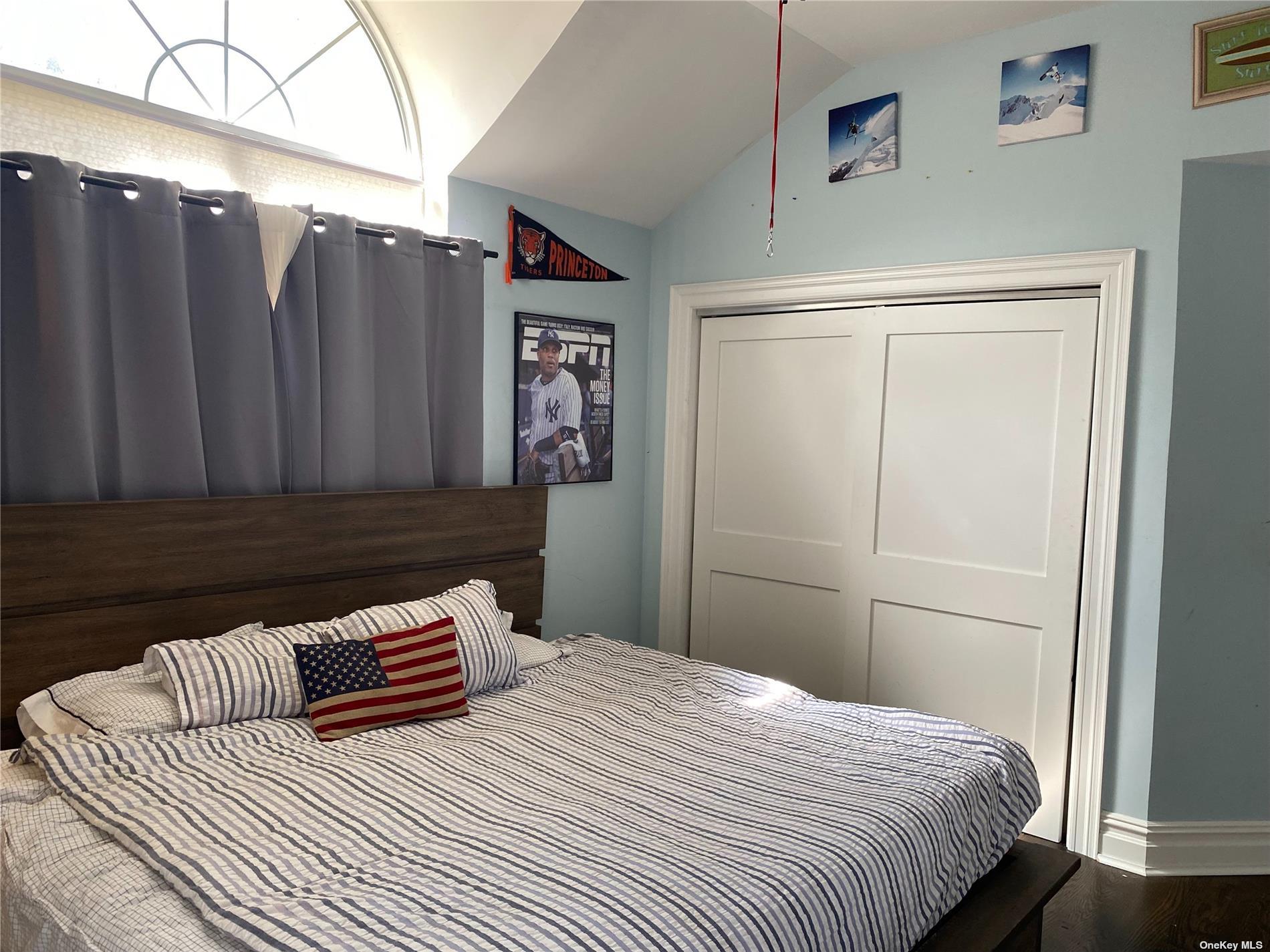 22 Drew Drive Eastport, NY 11941 - Photo 6 of 8 a bedroom with a bed and wooden floor