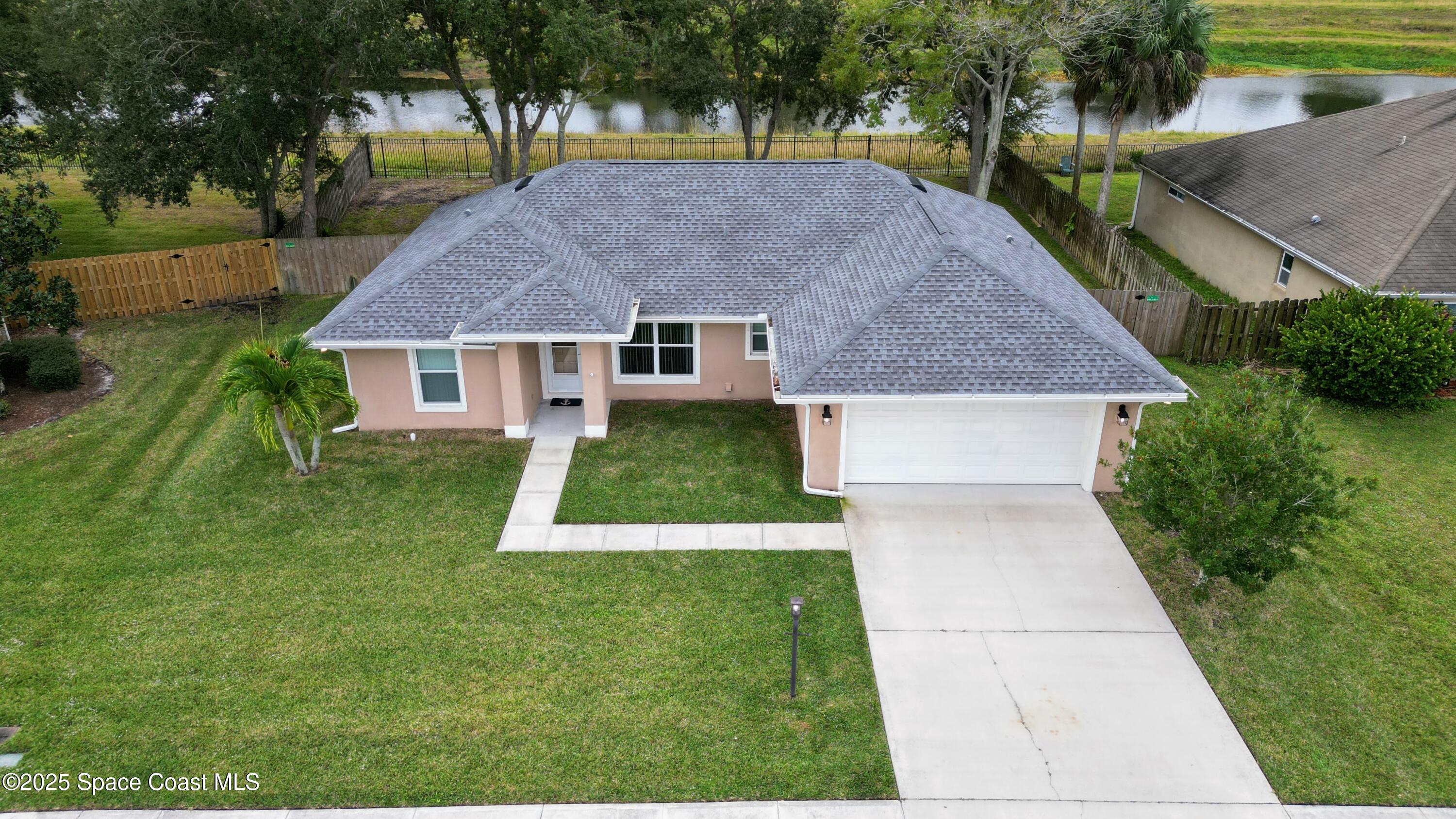 a aerial view of a house with a yard