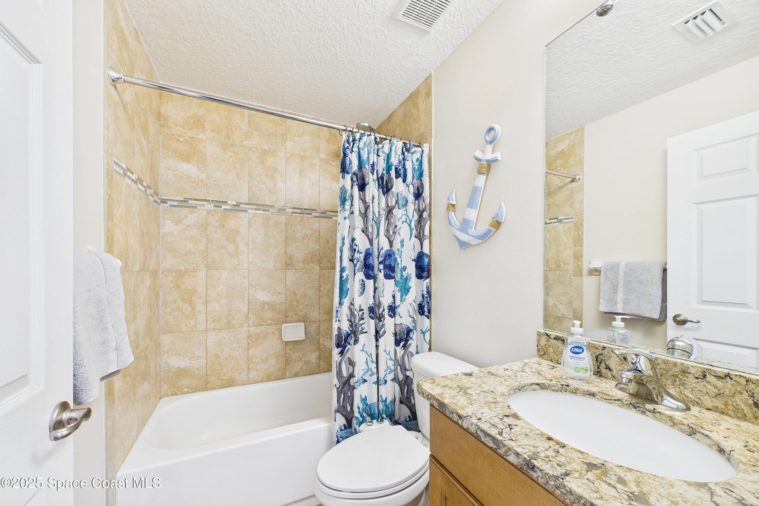 1936 Gloria Circle Palm Bay, FL 32905 - Photo 18 of 50 a bathroom with a granite countertop sink toilet and shower