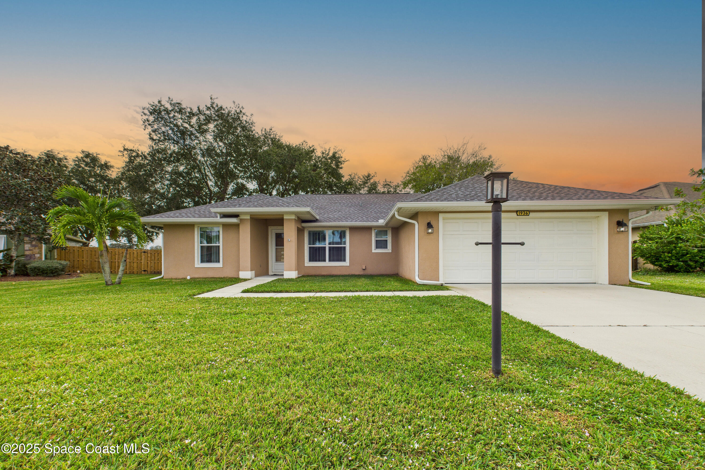 1936 Gloria Circle Palm Bay, FL 32905 - Photo 2 of 50 a front view of house with a garden