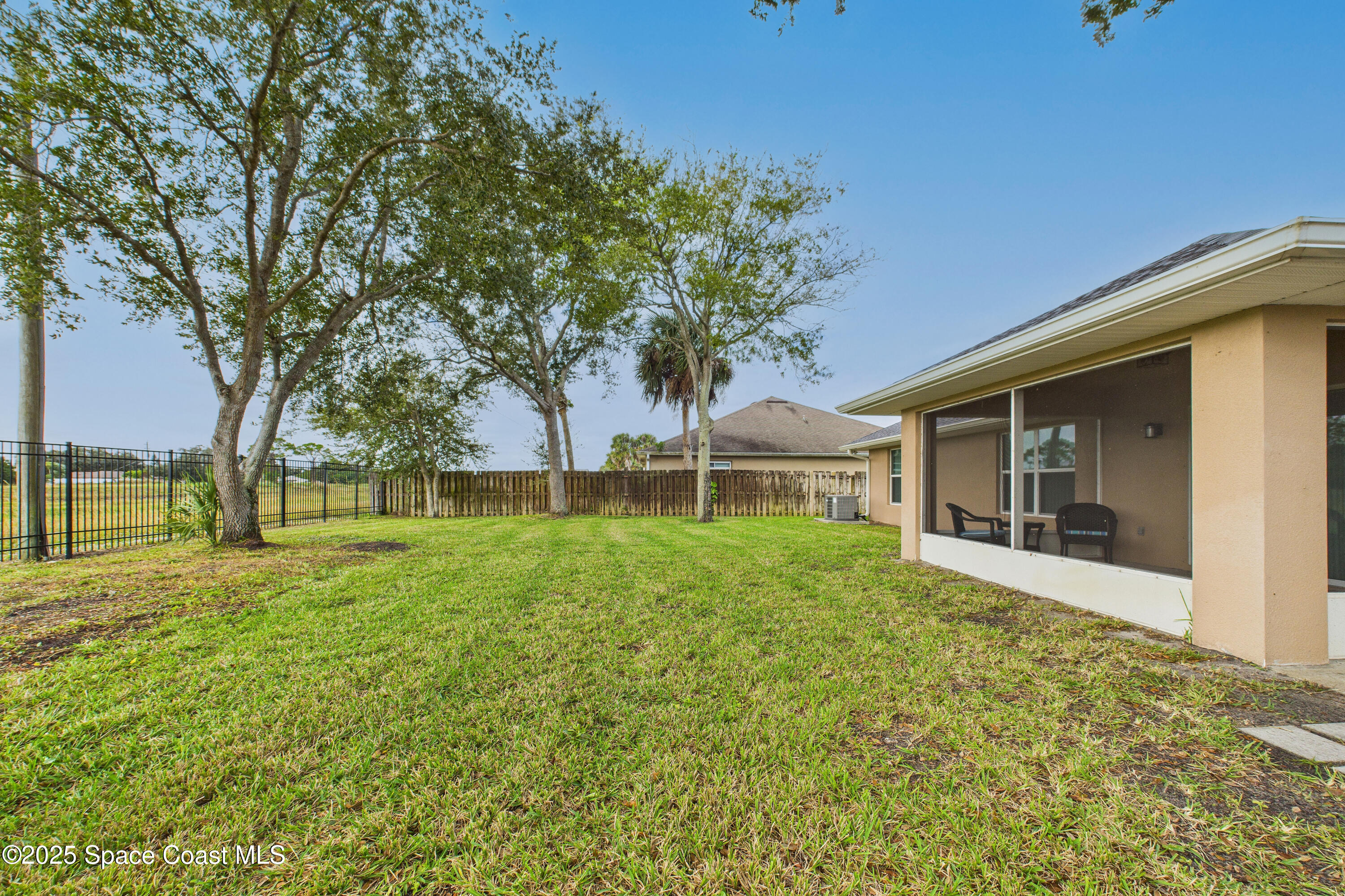1936 Gloria Circle Palm Bay, FL 32905 - Photo 39 of 50 a view of a house with yard and tree s
